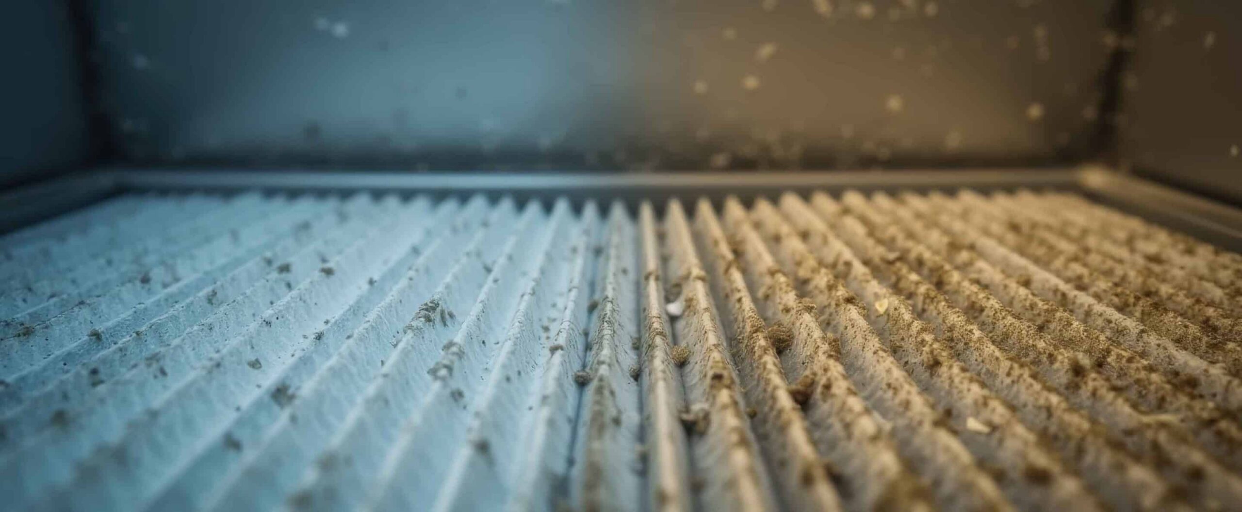 Close-up of an air filter shows a clean section on the left and a dust-covered, dirty furnace filters section on the right, clearly illustrating the difference before and after use.